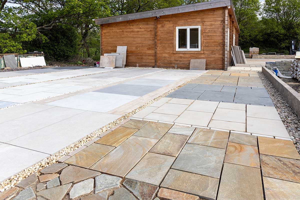 A view of lots of different types of paving and laying patterns on display outside the showroom and offices at Love Stone in Ewshot near Farnham