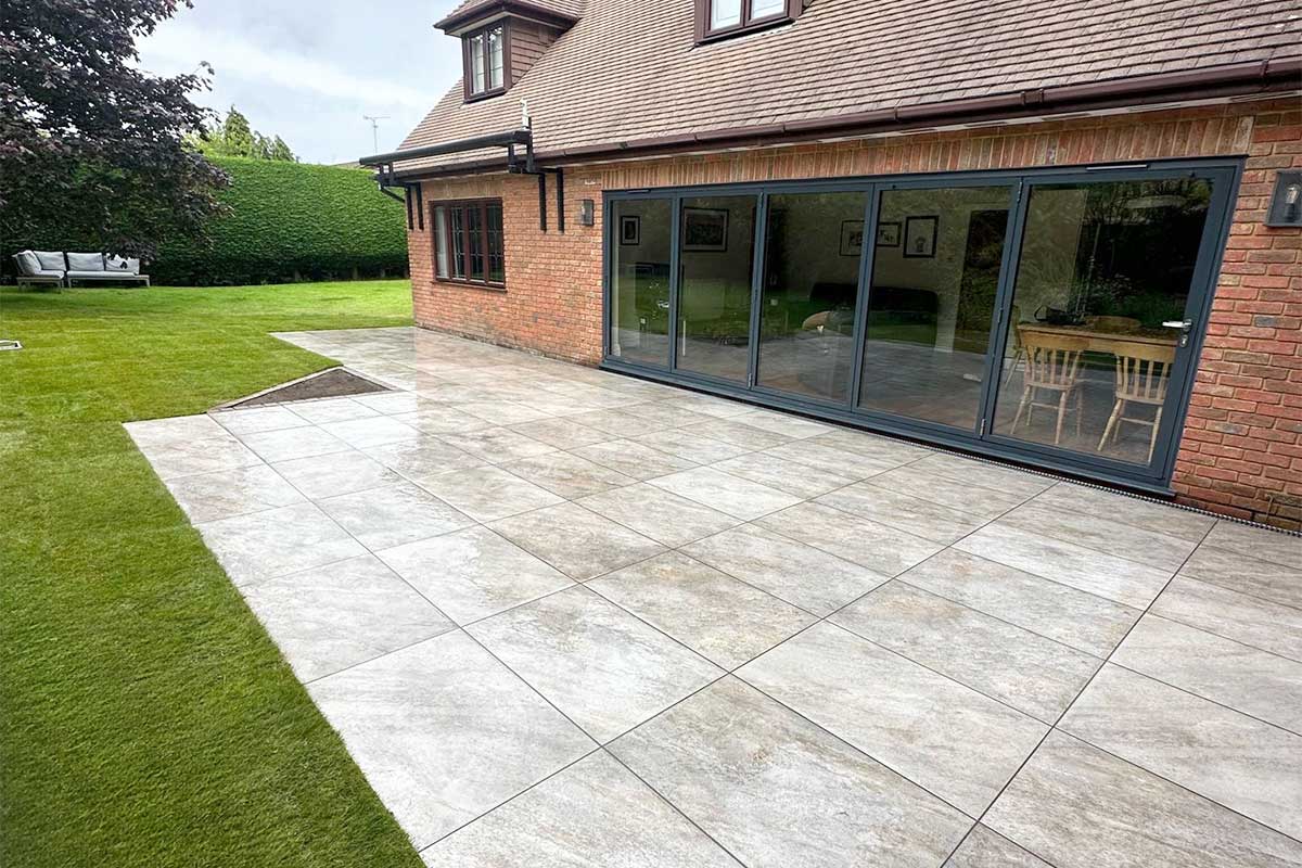 Large modern patio paved with Quartz Essence Wild stone effect porcelain paving in 900x600mm size from Love Stone