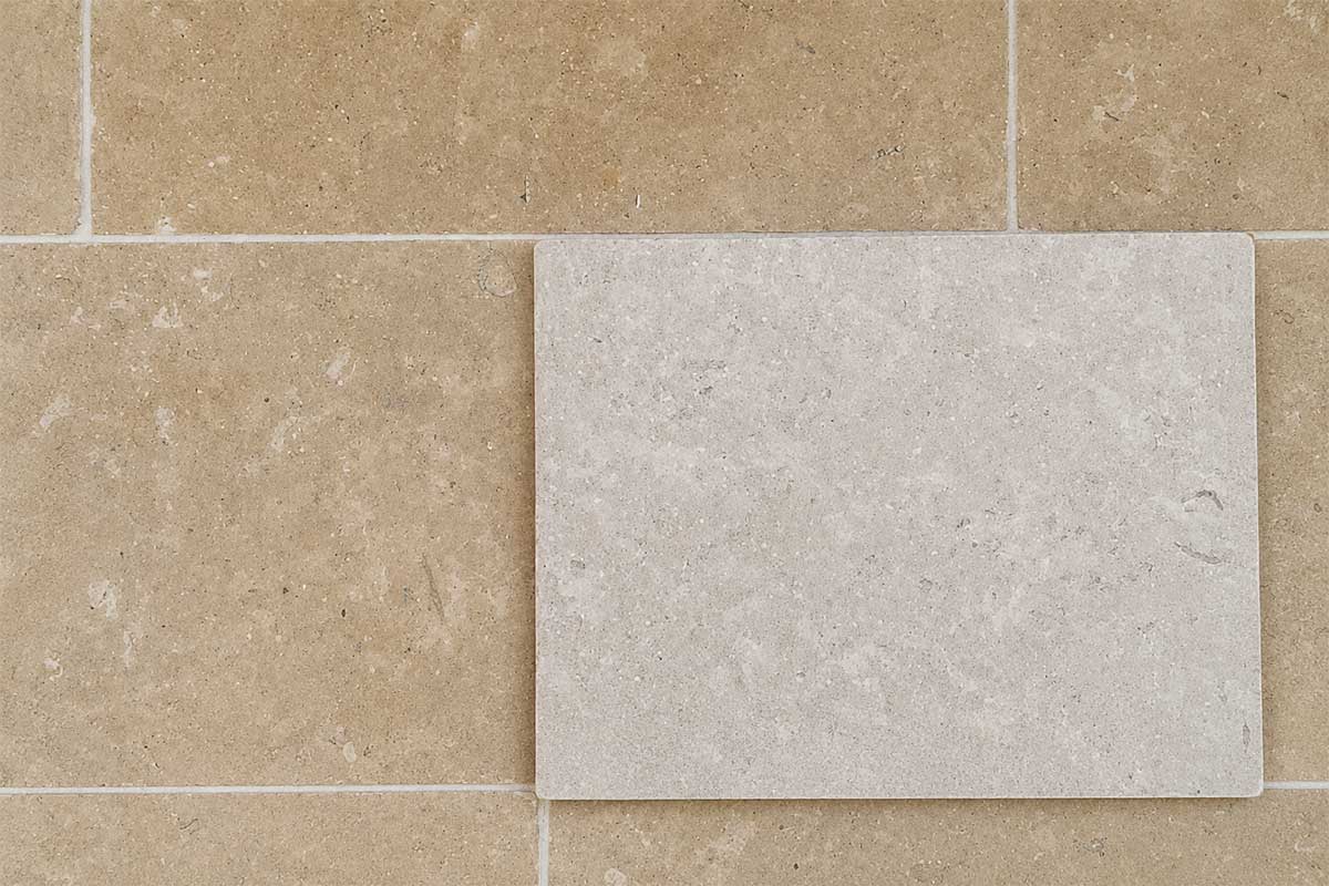 Image showing the different between unsealed stone paving and stone that has had a colour enhancing sealant applied to the surface