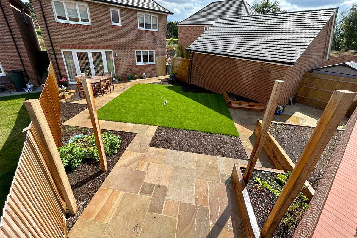 Fully landscaped rear garden near Farnham featuring Rippon Buff sandstone paving
