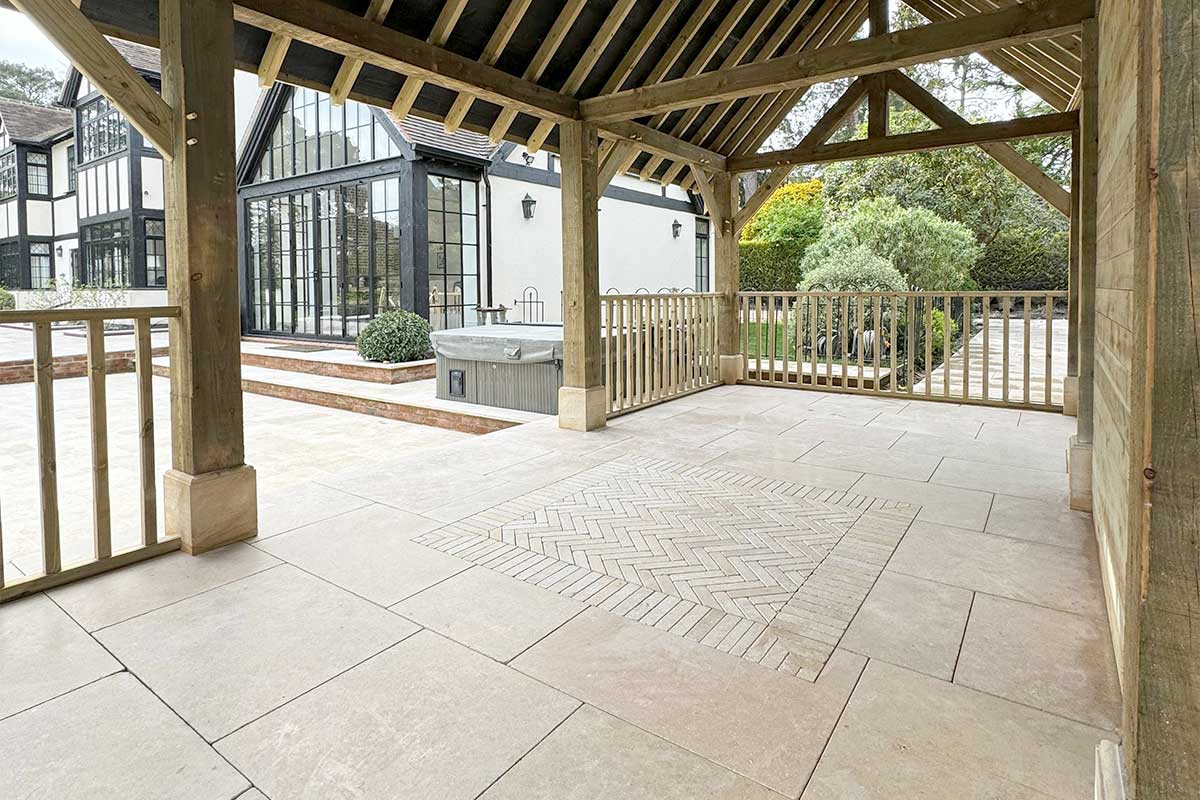 Very large patio and covered outdoor entertaining space featuring Sinai Pearl limestone paving with matching edging stone detailing