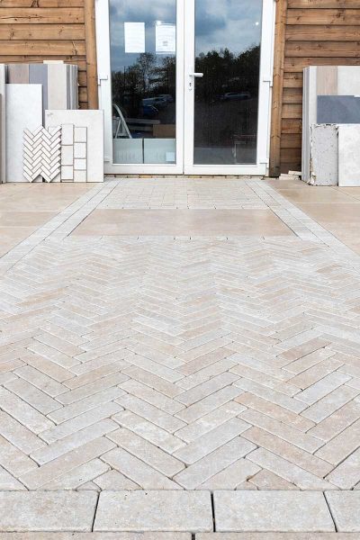 The entrance to the Love Stone paving showroom with feature limestone herringbone paved path