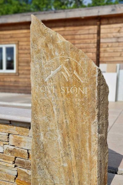 Bespoke stone monolith with carved Love Stone logo outside the entrance to the paving display area at Love Stone in Ewshot