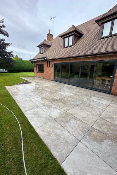 Large patio featuring stone effect porcelain paving from Love Stone