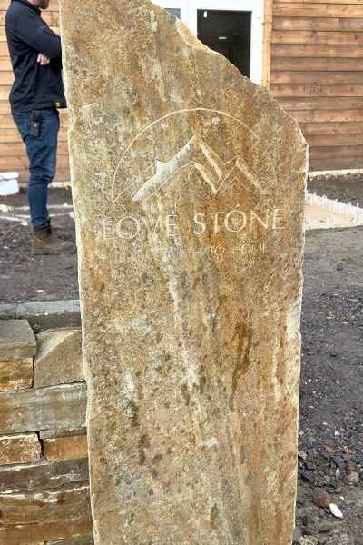 Bespoke stone sign showing the Love Stone Logo in front of the display area at their yard in Ewshot
